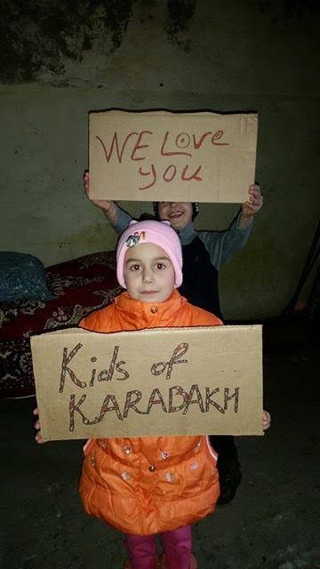 Children holding signs in appreciation of Kids of Karabakh