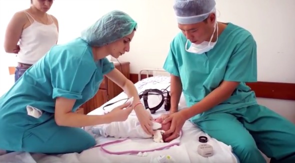 Dr. Sui Chien Wong treating an infant with debilitating eye disease, a condition that causes blindness (Photo: Armenian EyeCare Project/YouTube Screenshot)