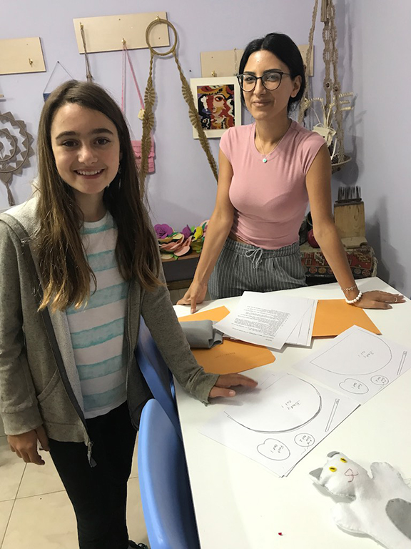 Ani teaching Hripsime Melkonyan Orran volunteer to make puppet templates