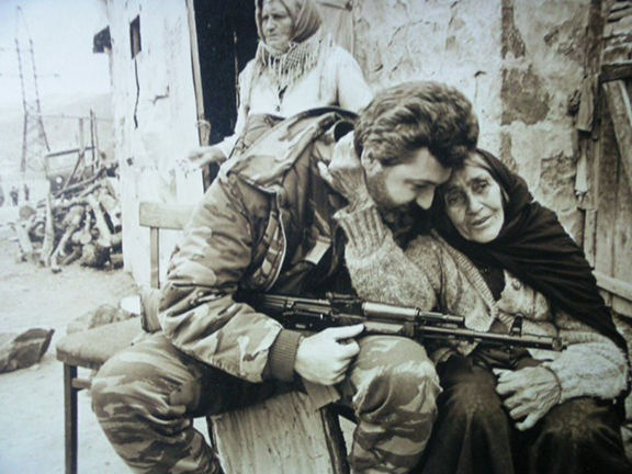 A photo of Hatspanian with an elderly woman became a symbol of the war. the photo had two stories—one very real, the other a complete lie. (Photo: Zaven Khachikyan)