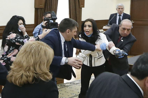 Yerkir Tsirani's Marina Khachatryan is being pulled and shoved during the Yerevan City Council meeting on Tuesday