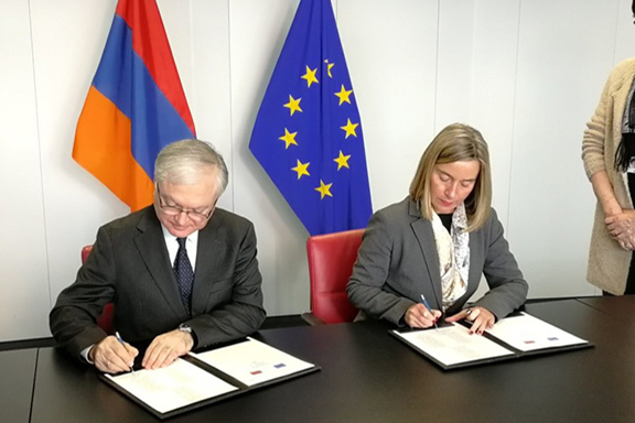 Armenia's Foreign Minister Edward Nalbandian with EU's High Representative for Foreign Affairs Federica Mogherini sign agreement in Brussels on Wednesday