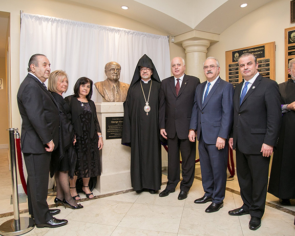 Prelate Archbishop Moushegh Mardirossian led a special unveiling ceremony of a statue honoring George Mardikian in the foyer of Bagramian Hall. From Left to Right: Haig and Argine Kelegian, who made the statue possible through their initiation and efforts; Goharik Gabriel, Chairperson of the Committee to Honor the Legacy of George Mardikian; Western Prelacy Prelate Archbishop Moushegh Mardirossian; Daron Der Khachadourian, ARF Western US Central Committee chairman; Levon Kirakosian, Esq., a member of the Committee to Honor the Legacy of George Mardikian and an ARF Western US Central Committee member; and Boghos Sassounian, ARF Dro Gomideh chairman.