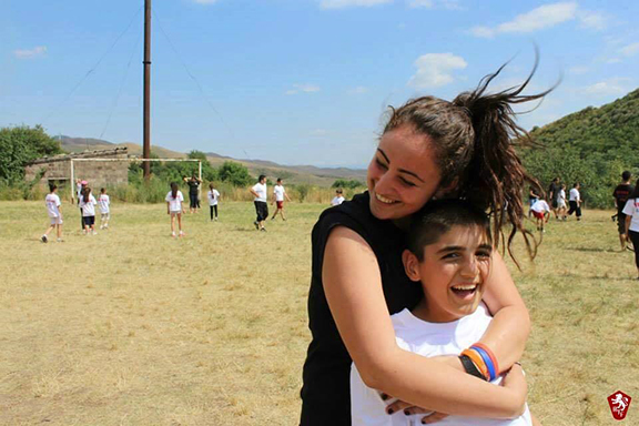 An AYF Youth Corps volunteer with one of the many local children impacted by the program