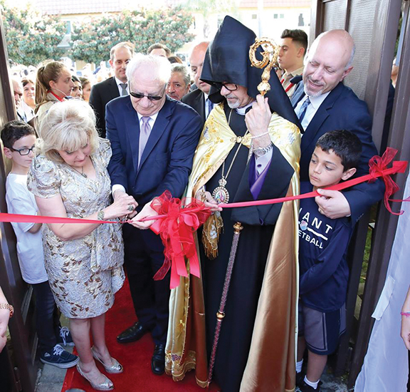 Meher and Satig Der Ohanessian cut the ribbon to the now eponymous center with Prelate Arch. Moushegh Mardirossian and ARF Zavarian Gomideh chairman Mike Kelechian