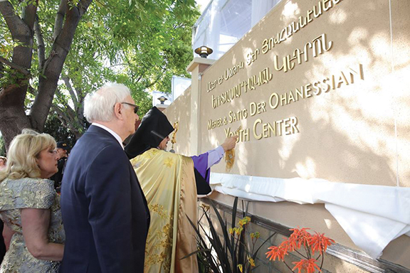 Prelate Marditossian blesses the sign baring the new center name