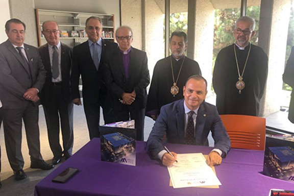 Glendale Mayor Zareh Sinanyan signs the land lease agreement as Armenian American Museum Board members look on