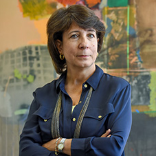 USC professor Salpi Ghazarian, Armenian Institute Director stands in front of painting done by an Armenian artist.
