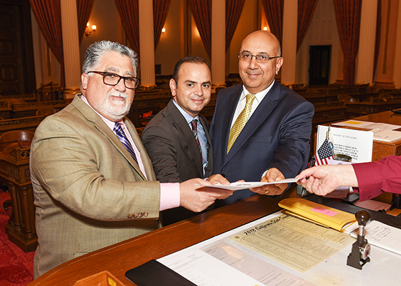 From left, Senator Anthony Portantino, Glendale Mayor Zareh Sinanyan and Armenia's Consul General to L.A. Armen Baibourtian submit SB 302