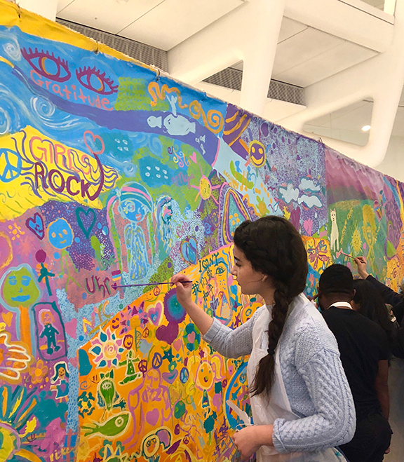 Paulette Markarian works on the mural that was displayed at UNICEF