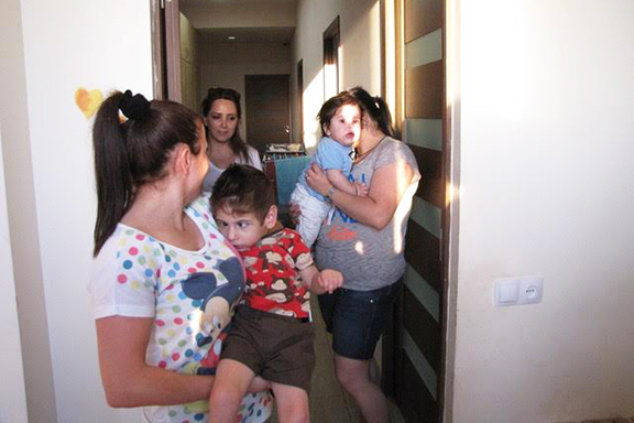 A Bari Doon physical therapist assists two mothers who have children with disabilities