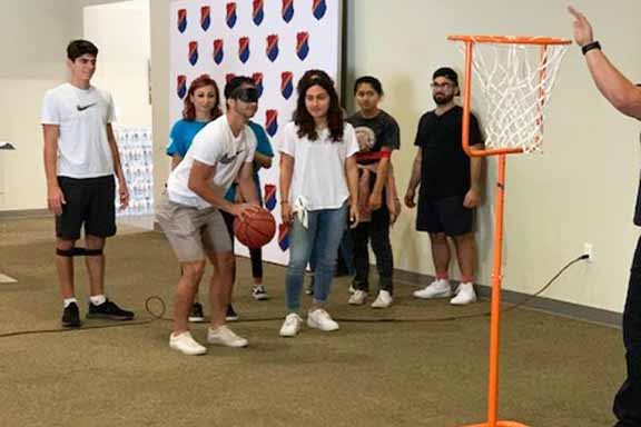 A "Hrashq" volunteer experiencing the challenges faced by a visually impaired athlete