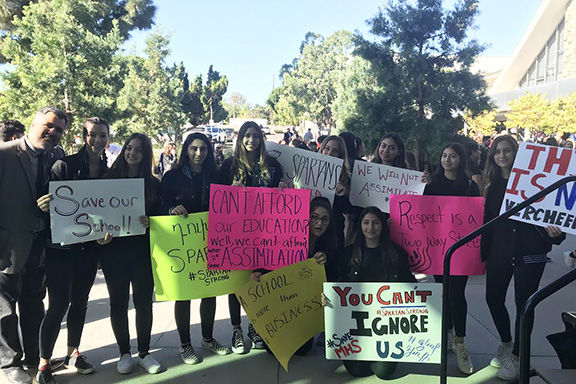 AGBU MHS students protested with signs that read "We Will Not Assimilate," and "Save Our School!"