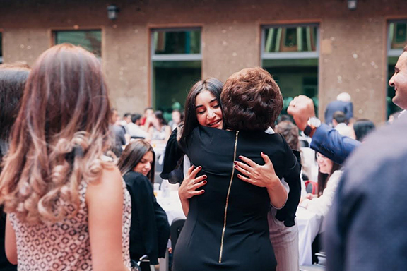 An AEF member embraces her sponsored student