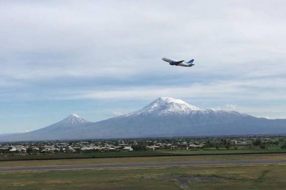 A plane flying above Mt. Ararat