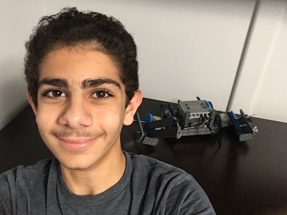 Mesrobian Distance Robotics Club member Michael Krikorian, eighth grade, with his robot.