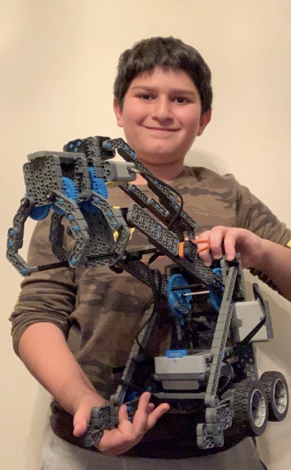 Mesrobian Distance Robotics Club member Larry Barseghian, seventh grade, with his robot.