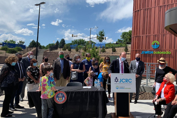 Colorado Governor Jared Polis signs the Genocide Education Bill at a ceremony on July 8.