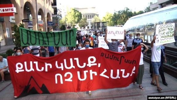Demonstrator protests plans to construct a gold mine in Amulsar on August 20