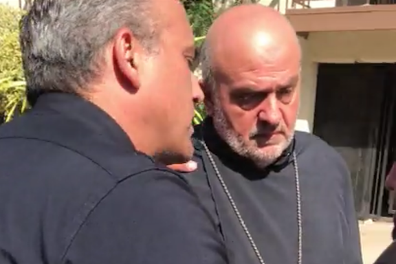Father Armen Bagramyan (right) with a LAPD officer during the July 21 event.