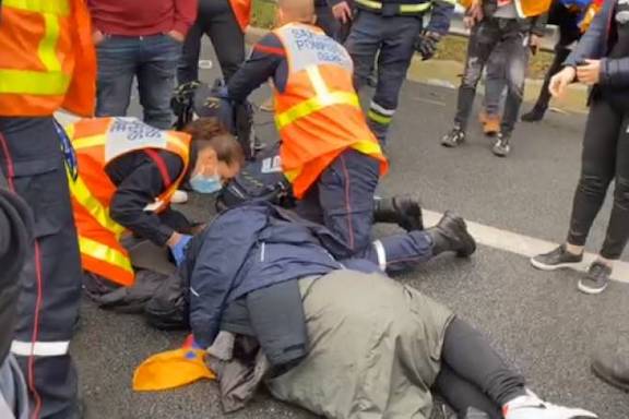 Paramedics tend to a protester who was hit in the head and lost consciousness